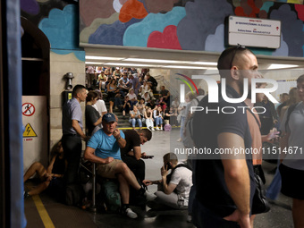 People shelter at the Osokorky metro station during the massive Russian drone and missile attack in Kyiv, Ukraine, on August 26, 2024. NO US...