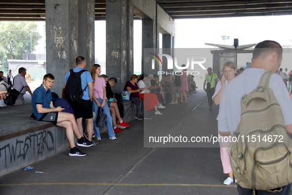 People stay under an overpass during the massive Russian drone and missile attack in Kyiv, Ukraine, on August 26, 2024. NO USE RUSSIA. NO US...