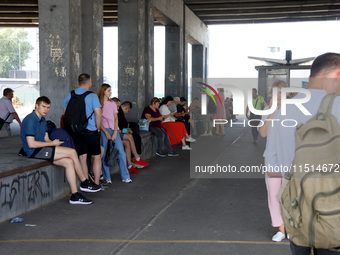 People stay under an overpass during the massive Russian drone and missile attack in Kyiv, Ukraine, on August 26, 2024. NO USE RUSSIA. NO US...