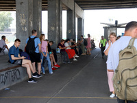 People stay under an overpass during the massive Russian drone and missile attack in Kyiv, Ukraine, on August 26, 2024. NO USE RUSSIA. NO US...