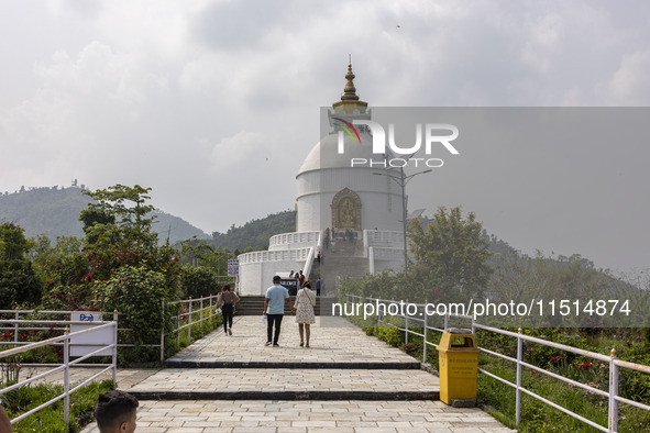 Shanti Stupa in Pokhara known as World Peace Pagoda with religious pilgrims and visitors, is a Buddhist monument situated at the height of 1...