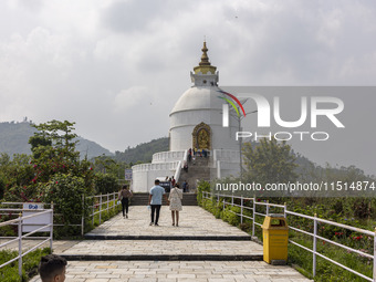 Shanti Stupa in Pokhara known as World Peace Pagoda with religious pilgrims and visitors, is a Buddhist monument situated at the height of 1...