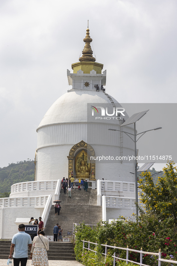 Shanti Stupa in Pokhara known as World Peace Pagoda with religious pilgrims and visitors, is a Buddhist monument situated at the height of 1...