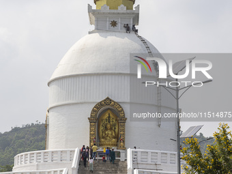 Shanti Stupa in Pokhara known as World Peace Pagoda with religious pilgrims and visitors, is a Buddhist monument situated at the height of 1...