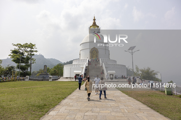 Shanti Stupa in Pokhara known as World Peace Pagoda with religious pilgrims and visitors, is a Buddhist monument situated at the height of 1...