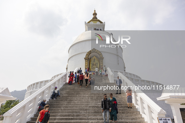 Shanti Stupa in Pokhara known as World Peace Pagoda with religious pilgrims and visitors, is a Buddhist monument situated at the height of 1...