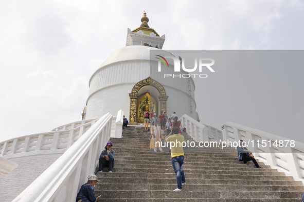 Shanti Stupa in Pokhara known as World Peace Pagoda with religious pilgrims and visitors, is a Buddhist monument situated at the height of 1...