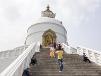 Shanti Stupa in Pokhara known as World Peace Pagoda with religious pilgrims and visitors, is a Buddhist monument situated at the height of 1...