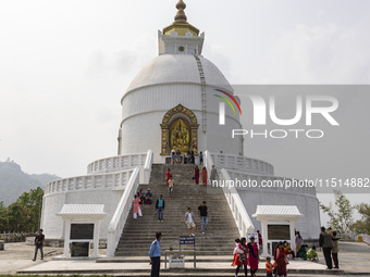 Shanti Stupa in Pokhara known as World Peace Pagoda with religious pilgrims and visitors, is a Buddhist monument situated at the height of 1...