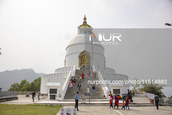 Shanti Stupa in Pokhara known as World Peace Pagoda with religious pilgrims and visitors, is a Buddhist monument situated at the height of 1...