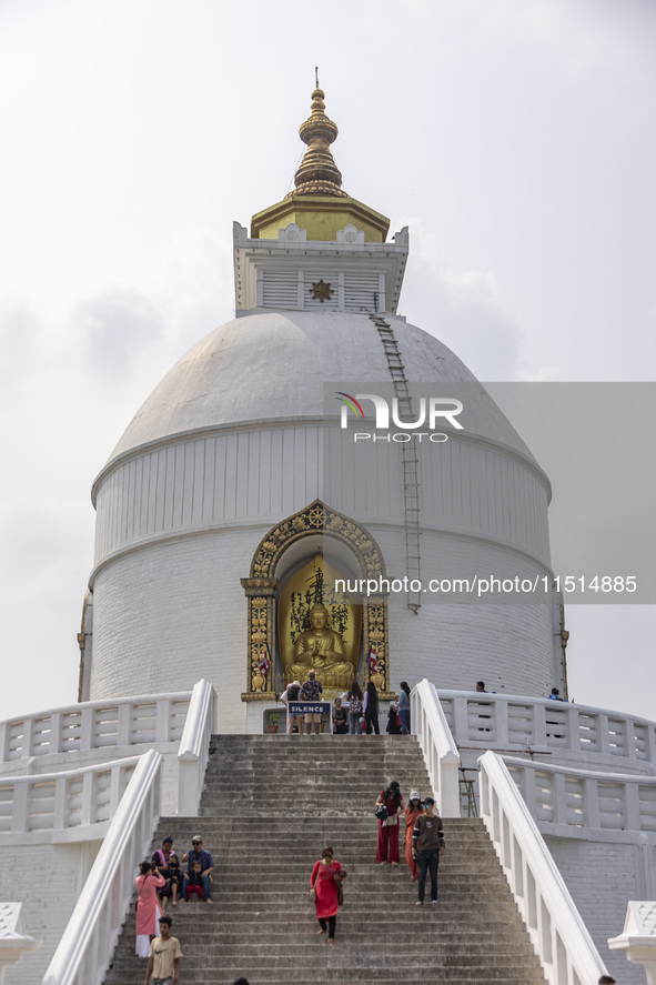 Shanti Stupa in Pokhara known as World Peace Pagoda with religious pilgrims and visitors, is a Buddhist monument situated at the height of 1...