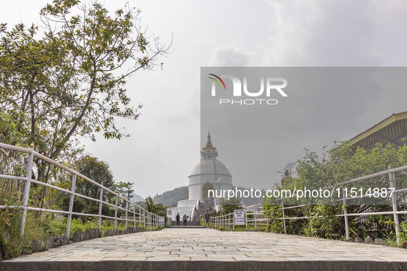 Shanti Stupa in Pokhara known as World Peace Pagoda with religious pilgrims and visitors, is a Buddhist monument situated at the height of 1...