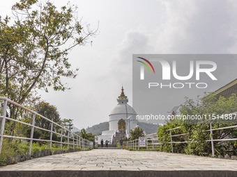 Shanti Stupa in Pokhara known as World Peace Pagoda with religious pilgrims and visitors, is a Buddhist monument situated at the height of 1...