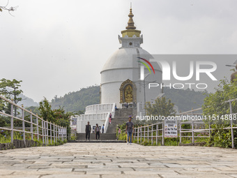 Shanti Stupa in Pokhara known as World Peace Pagoda with religious pilgrims and visitors, is a Buddhist monument situated at the height of 1...