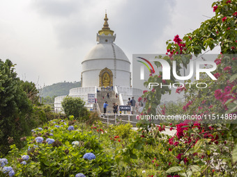 Shanti Stupa in Pokhara known as World Peace Pagoda with religious pilgrims and visitors, is a Buddhist monument situated at the height of 1...