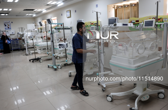 A Palestinian medic prepares to evacuate premature babies from the Al-Aqsa Martyrs Hospital in Deir al-Balah in the central Gaza Strip follo...