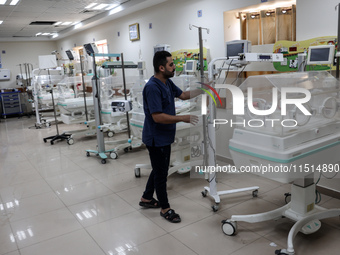 A Palestinian medic prepares to evacuate premature babies from the Al-Aqsa Martyrs Hospital in Deir al-Balah in the central Gaza Strip follo...