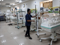 A Palestinian medic prepares to evacuate premature babies from the Al-Aqsa Martyrs Hospital in Deir al-Balah in the central Gaza Strip follo...