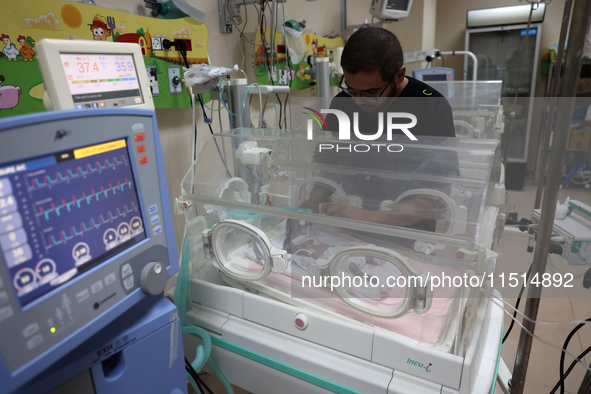 A Palestinian medic prepares to evacuate premature babies from the Al-Aqsa Martyrs Hospital in Deir al-Balah in the central Gaza Strip follo...