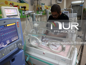 A Palestinian medic prepares to evacuate premature babies from the Al-Aqsa Martyrs Hospital in Deir al-Balah in the central Gaza Strip follo...