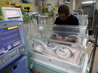 A Palestinian medic prepares to evacuate premature babies from the Al-Aqsa Martyrs Hospital in Deir al-Balah in the central Gaza Strip follo...