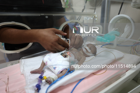 A Palestinian medic prepares to evacuate premature babies from the Al-Aqsa Martyrs Hospital in Deir al-Balah in the central Gaza Strip follo...