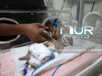 A Palestinian medic prepares to evacuate premature babies from the Al-Aqsa Martyrs Hospital in Deir al-Balah in the central Gaza Strip follo...