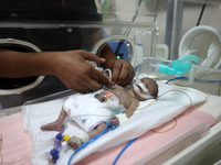 A Palestinian medic prepares to evacuate premature babies from the Al-Aqsa Martyrs Hospital in Deir al-Balah in the central Gaza Strip follo...