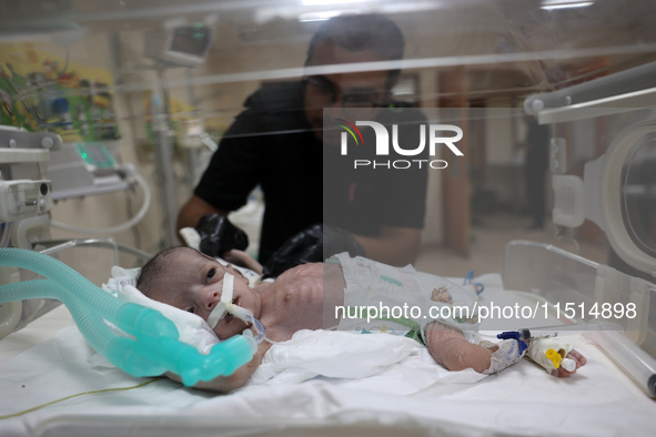 A Palestinian medic prepares to evacuate premature babies from the Al-Aqsa Martyrs Hospital in Deir al-Balah in the central Gaza Strip follo...