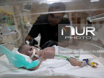 A Palestinian medic prepares to evacuate premature babies from the Al-Aqsa Martyrs Hospital in Deir al-Balah in the central Gaza Strip follo...