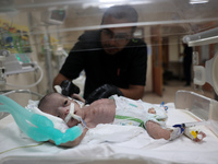 A Palestinian medic prepares to evacuate premature babies from the Al-Aqsa Martyrs Hospital in Deir al-Balah in the central Gaza Strip follo...