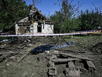 The body of a man killed by the Russian missile attack is on the ground in the human remains pouch outside his house in Zaporizhzhia region,...