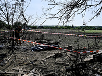 The body of a man killed by the Russian missile attack is on the ground in the human remains pouch outside his house in Zaporizhzhia region,...