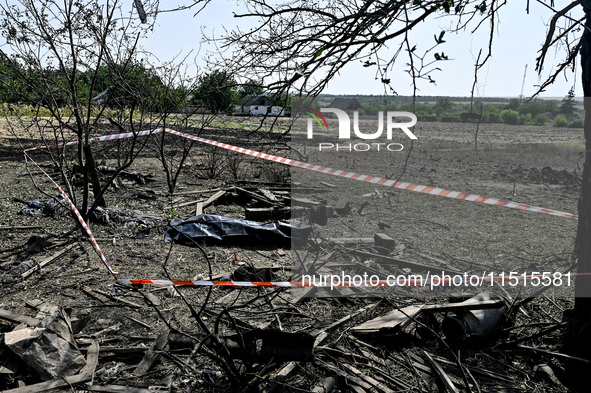 The body of a man killed by the Russian missile attack is on the ground in the human remains pouch outside his house in Zaporizhzhia region,...