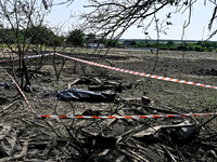 The body of a man killed by the Russian missile attack is on the ground in the human remains pouch outside his house in Zaporizhzhia region,...