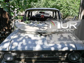 A damaged car is at the house of a victim of the Russian missile attack in Zaporizhzhia region, Ukraine, on August 26, 2024. NO USE RUSSIA....