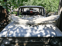 A damaged car is at the house of a victim of the Russian missile attack in Zaporizhzhia region, Ukraine, on August 26, 2024. NO USE RUSSIA....