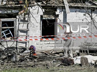 An elderly woman stands outside a house after the owner is killed by a Russian missile attack in the Zaporizhzhia region, Ukraine, on August...