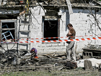 An elderly woman stands outside a house after the owner is killed by a Russian missile attack in the Zaporizhzhia region, Ukraine, on August...