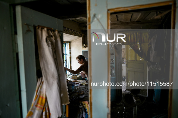 A woman stands in the damaged house of a man killed by the Russian missile attack in the Zaporizhzhia region, Ukraine, on August 26, 2024. N...