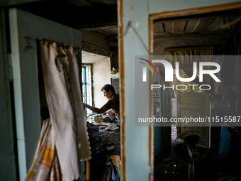 A woman stands in the damaged house of a man killed by the Russian missile attack in the Zaporizhzhia region, Ukraine, on August 26, 2024. N...