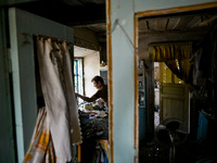 A woman stands in the damaged house of a man killed by the Russian missile attack in the Zaporizhzhia region, Ukraine, on August 26, 2024. N...