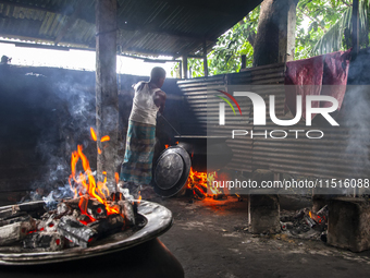 A cook prepares lunch for flood-affected people in the Aburhat area of Mirsharai Upazila, Chittagong Division, Bangladesh, on August 26, 202...