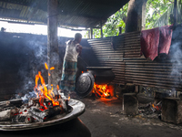 A cook prepares lunch for flood-affected people in the Aburhat area of Mirsharai Upazila, Chittagong Division, Bangladesh, on August 26, 202...