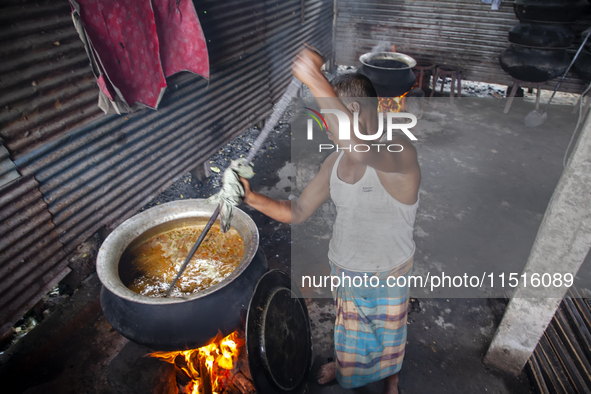 A cook prepares lunch for flood-affected people in the Aburhat area of Mirsharai Upazila, Chittagong Division, Bangladesh, on August 26, 202...