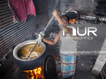 A cook prepares lunch for flood-affected people in the Aburhat area of Mirsharai Upazila, Chittagong Division, Bangladesh, on August 26, 202...