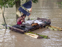 A small child sits on a banana raft in the Aburhat area of Mirsarai Upazila, Chittagong Division, Bangladesh, on August 26, 2024. At least 1...