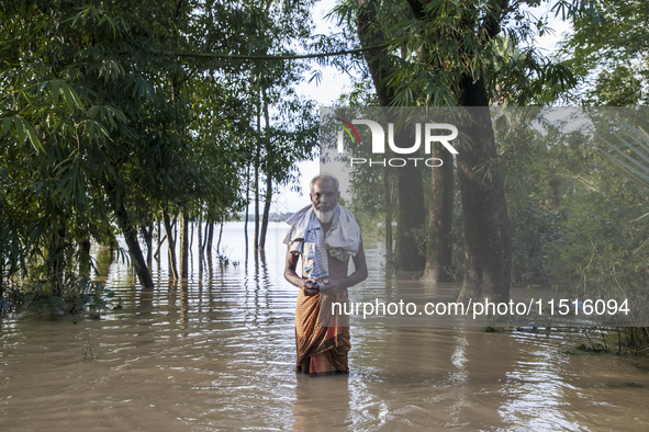 An elderly man stands on a flooded road in the Aburhat area of Mirsarai Upazila in Chittagong Division, Bangladesh, on August 26, 2024. At l...