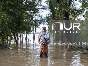 An elderly man stands on a flooded road in the Aburhat area of Mirsarai Upazila in Chittagong Division, Bangladesh, on August 26, 2024. At l...