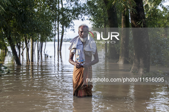 An elderly man stands on a flooded road in the Aburhat area of Mirsarai Upazila in Chittagong Division, Bangladesh, on August 26, 2024. At l...